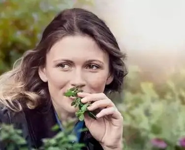 Lady smelling herbs